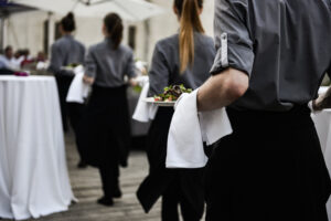 Waiter,Carrying,Plates,With,Meat,Dish,On,Some,Festive,Event