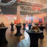 Elegant,Event,Space,With,Cocktail,Tables,,Floral,Arrangements,,Ambient,Lighting,