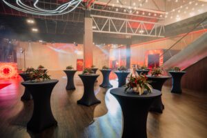 Elegant,Event,Space,With,Cocktail,Tables,,Floral,Arrangements,,Ambient,Lighting,