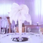 A Hollywood glamour event in Surrey with giant white feather table Centrepieces.
