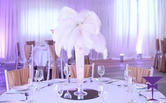 A Hollywood glamour event in Surrey with giant white feather table Centrepieces.
