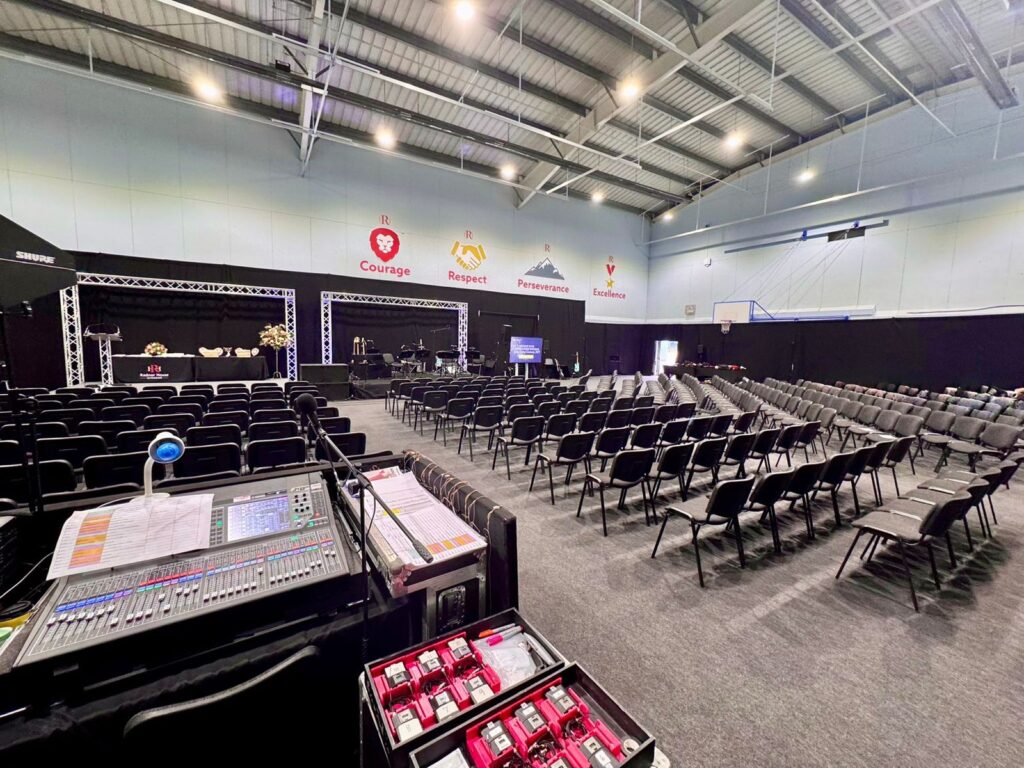 big conference room with 100 black foldable chairs and sound bar