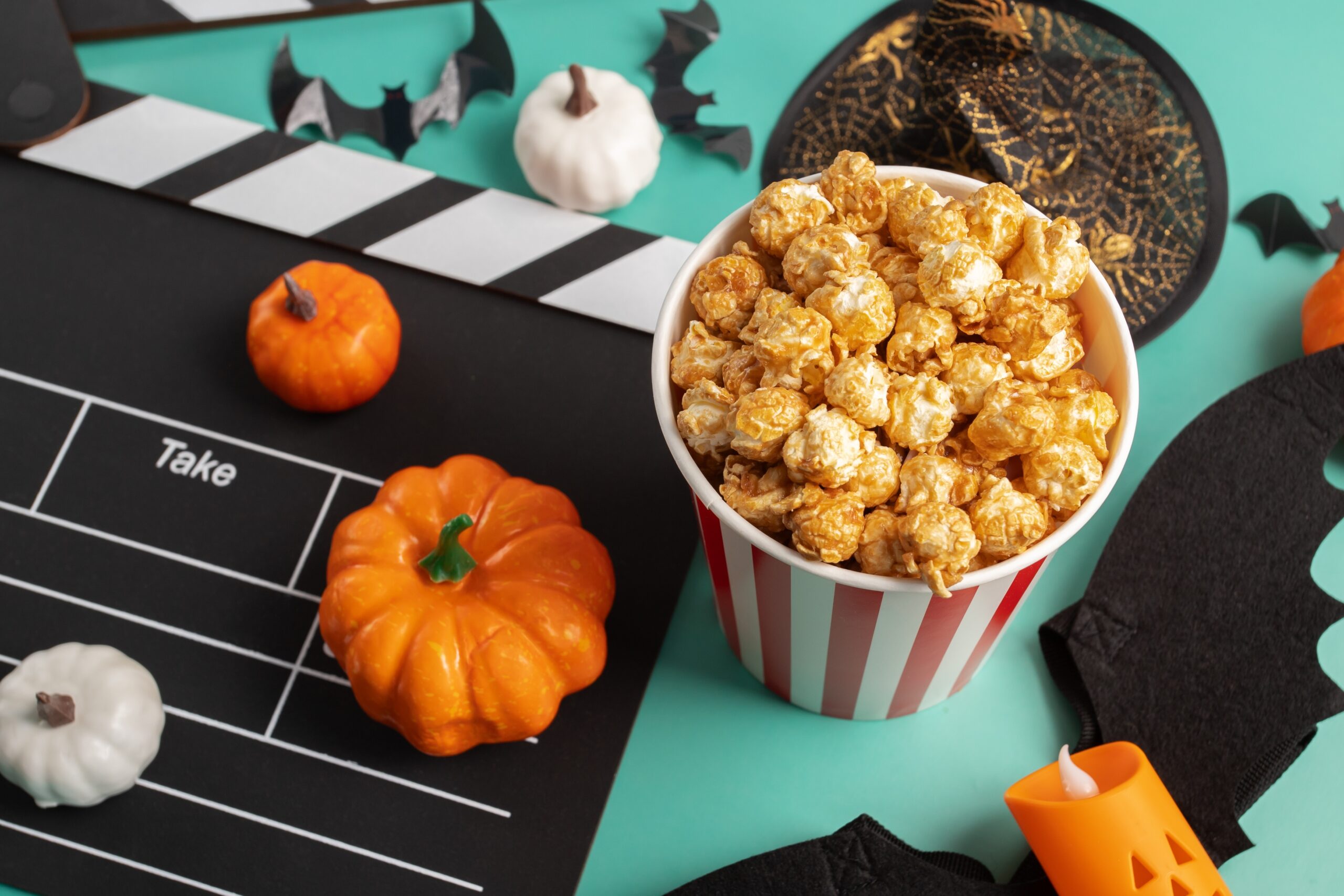 Movie,Clapperboard,And,Halloween,Decorations,With,Popcorn,On,Green,Background,